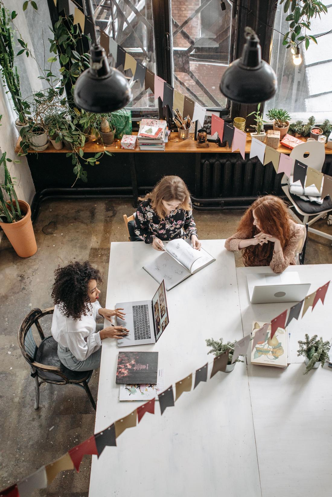 A small team working together around a long table